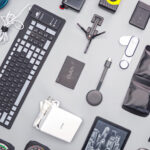 Stylized collage of the top 5 must-have tech gadgets for 2025, featuring a smart ring and AI glasses