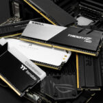 A glowing stick of high-performance DDR5 RAM held in front of a vibrant, out-of-focus gaming PC background, illustrating the importance of RAM for gaming in 2025.