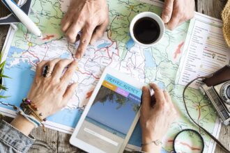 A diverse collage of travel destinations - a beach, a mountain, and a city - with the text "The Ultimate Beginner's Guide to Planning a Vacation" overlaid.