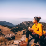 A woman hiking alone in the mountains of Iceland with a backpack(solo female travel).