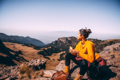 A woman hiking alone in the mountains of Iceland with a backpack(solo female travel).