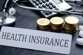 A person reviewing their health insurance policy with a magnifying glass, illustrating the importance of understanding premiums and costs