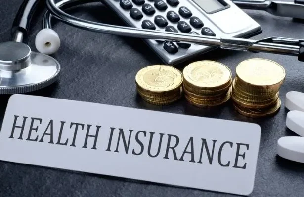A person reviewing their health insurance policy with a magnifying glass, illustrating the importance of understanding premiums and costs