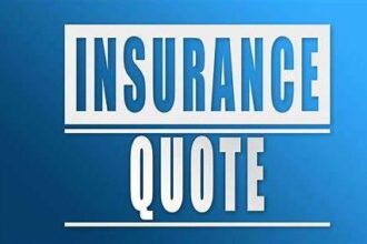 A smiling person sits at a desk with a laptop, confidently comparing auto insurance quotes online to find the best rates