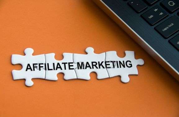 Infographic explaining the affiliate marketing model with the merchant, affiliate network, affiliate, and customer.